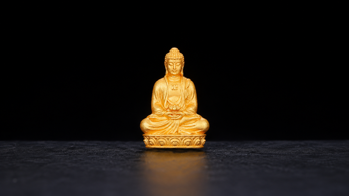 Centered full Amitabha seated Buddha figure on black background