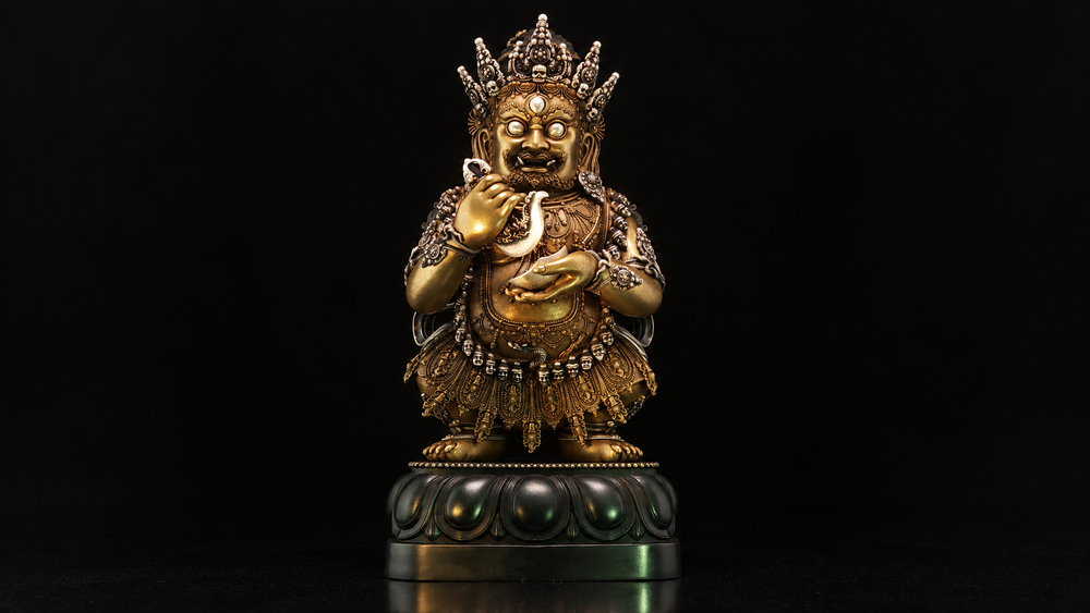 Centered full seated Mahakala figure with skull crown, curved knife, cup, and lotus base