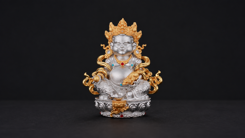 Silver-tone seated Yellow Jambhala figure with gold-tone crown, mongoose-like attribute, and lotus-style pedestal fully visible against a dark background.