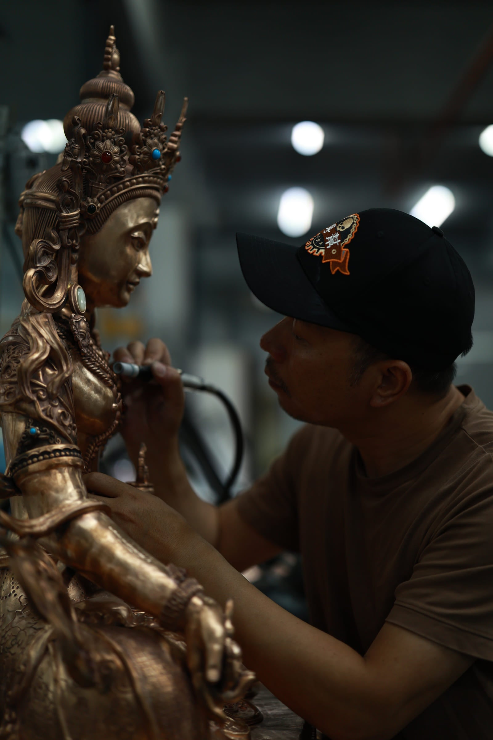 LIKREAT artisan working on a sculptural object