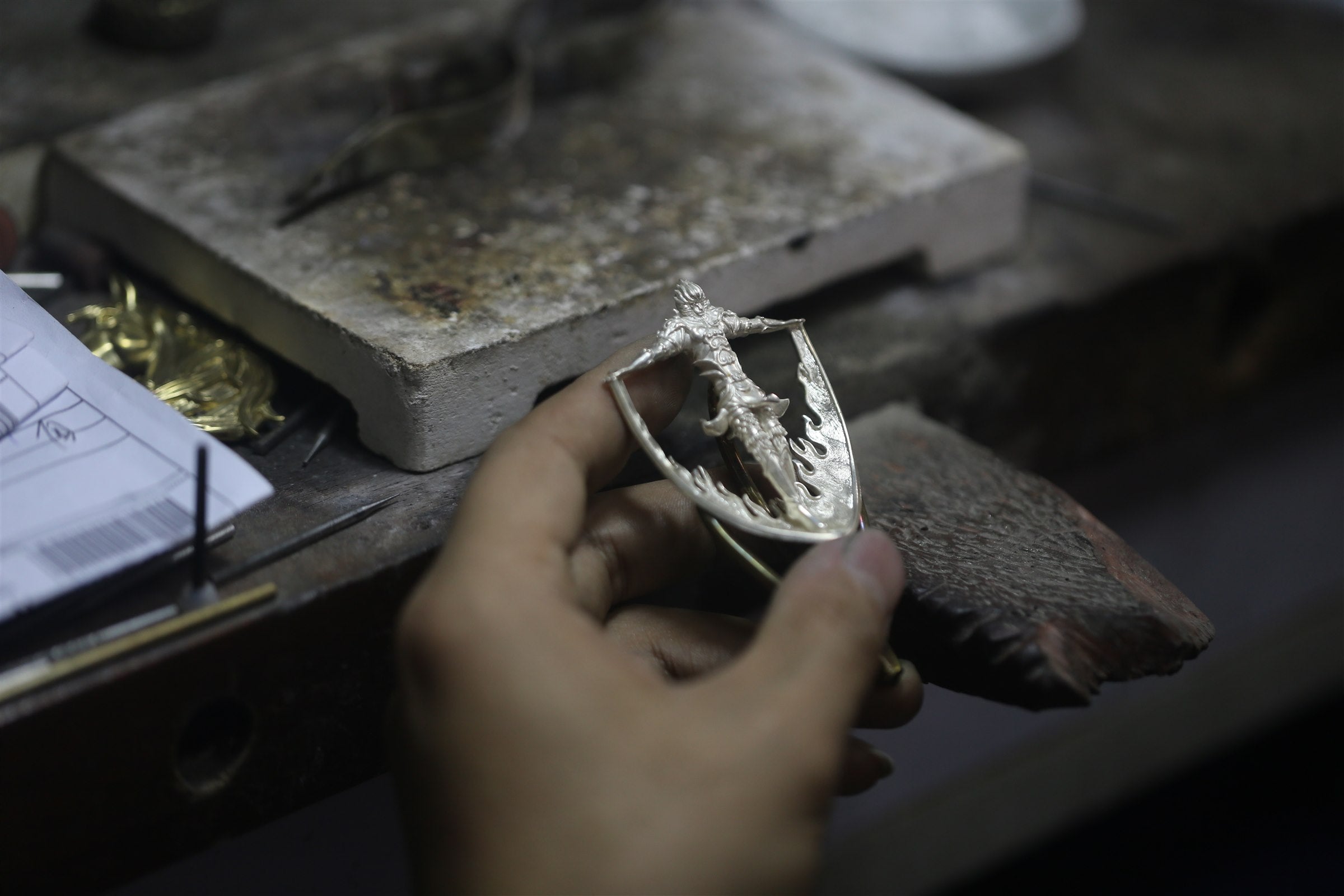 Silver Garuda form being refined at the workbench