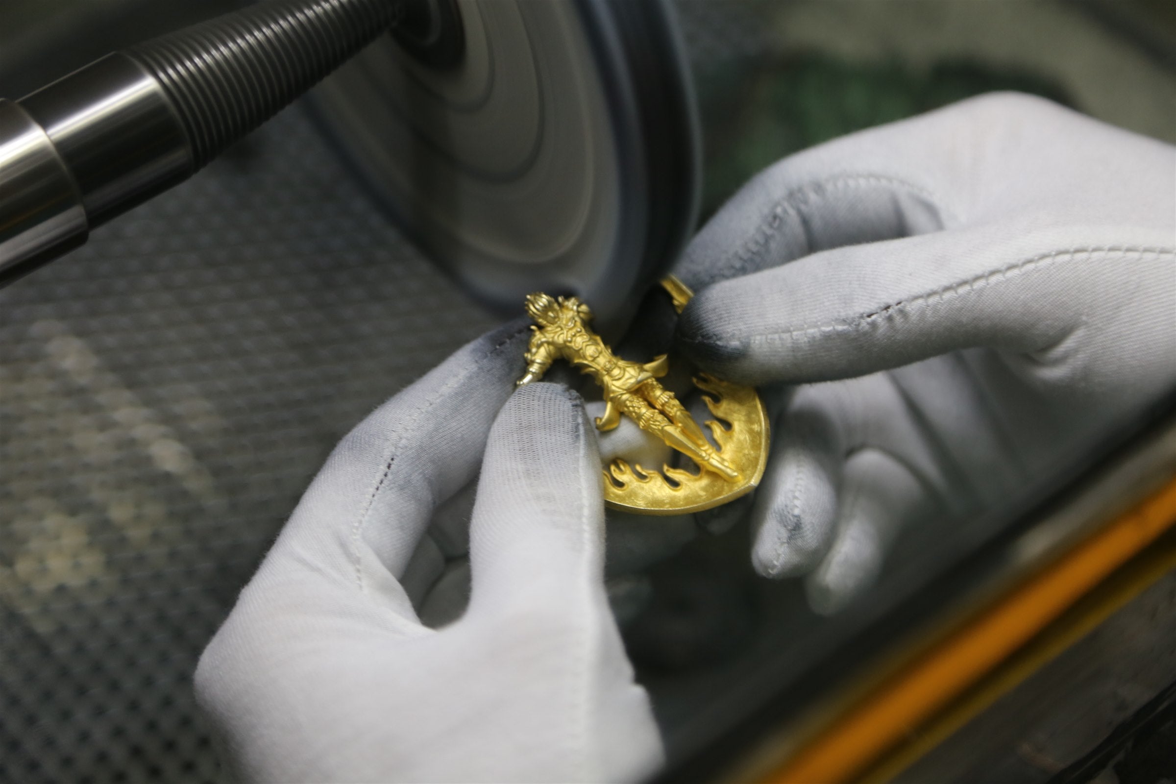 Artisan polishing the gold Garuda form